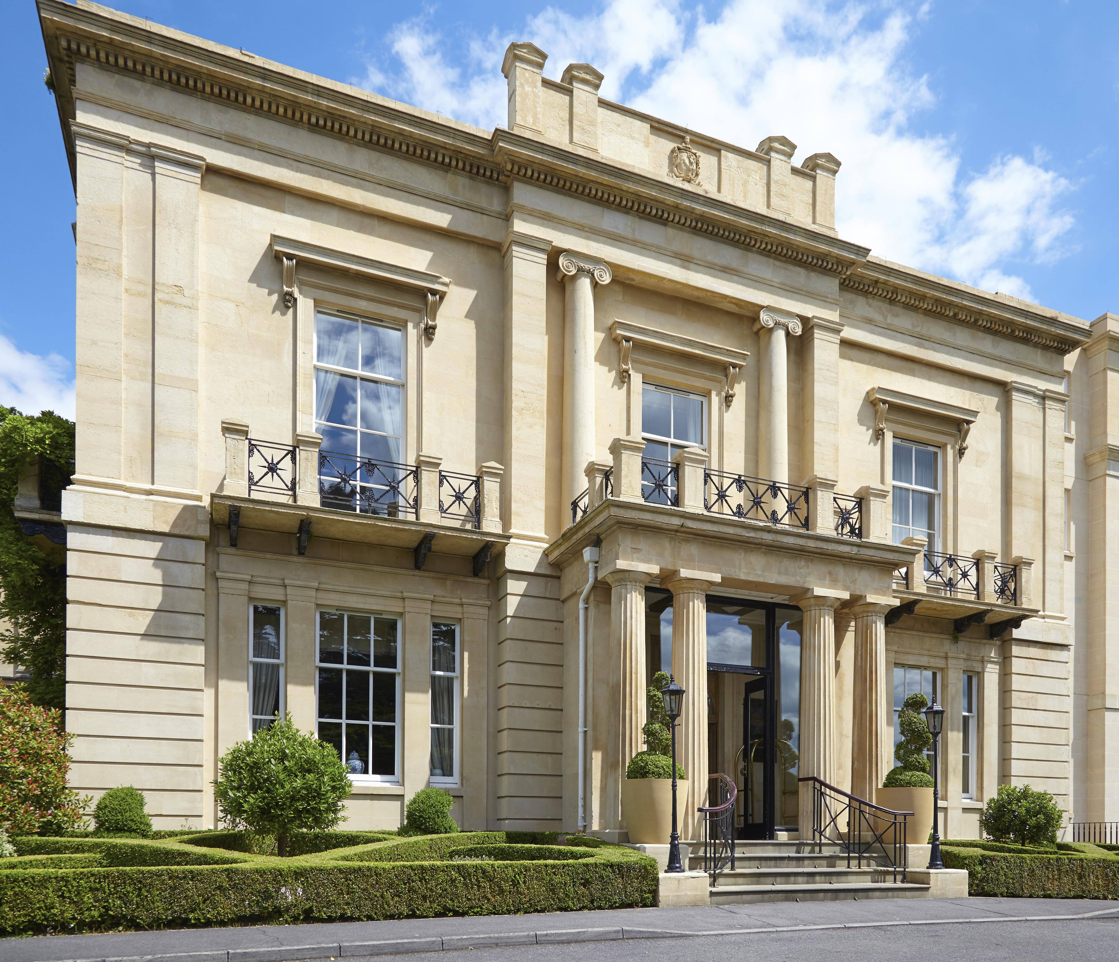 Macdonald Bath Spa Hotel Buitenkant foto The photo shows a large, elegant building designed in a classical architectural style. It features a symmetrical facade with tall columns and decorative details. The entrance is marked by a set of stairs leading up to double doors, flanked by windows